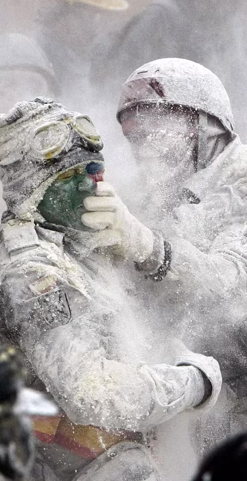 Image: People take part in the flour fight as part of the winter festival in Ibi, Alicante, eastern Spain