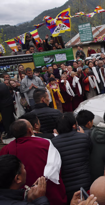 Image: Exile Tibetans welcome their spiritual leader the Dalai Lama as he arrives in Dharamsala