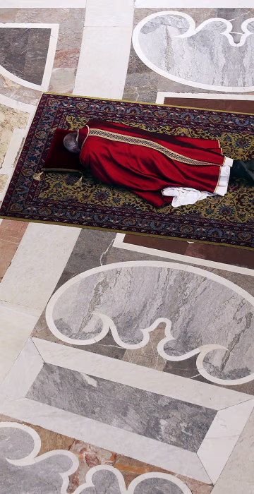 Image: Pope Francis lies as he prays during the Celebration of the Lord's Passion in Saint Peter's Basilica at the Vatican