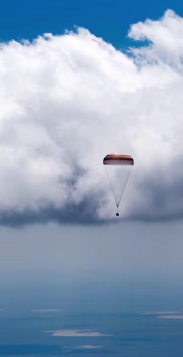 Image: Soyuz TMA-19M spacecraft capsule carrying ISS crew members descends beneath parachute near Dzhezkazgan