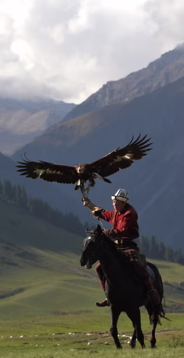 Image: A mounted Kyrgyz berkutchi holds his golden eagle during the World Nomad Games 2016
