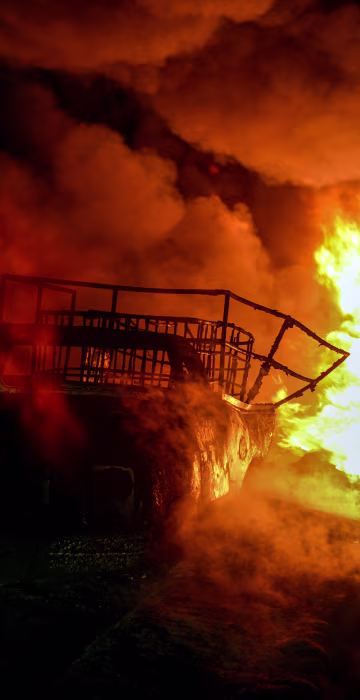 Image: Firefighters work to quell a fire on an alleged clandestine gasoline storage