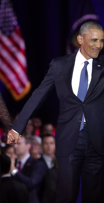 Image: First Lady Michelle Obama and President Barack Obama greet supporters as daughter Malia looks on after the President delivered his farewell address in Chicago, Illinois on Jan. 10.
