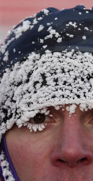 Image: A runner with his face covered with hoarfrost competes during the traditional half Marathon amateur competition marking the Orthodox Christmas Day festivities.