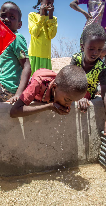 Image: Children drink water delivered by a truck in the drought-stricken Baligubadle village in this handout provided by The International Federation of Red Cross and Red Crescent Societies on March 15.