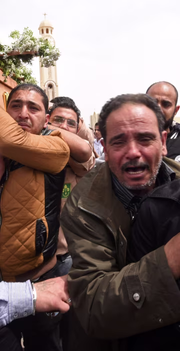 Image: Family members carry the coffin of a victim from Alexandria during a funeral procession at the Monastery of Marmina in the city of Borg El-Arab, April 10.
