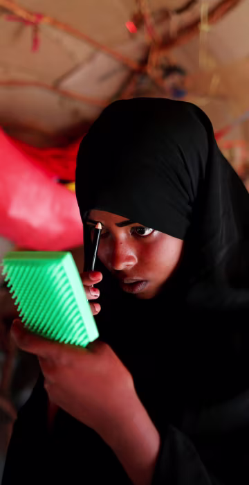 Image: The Wider Image: A daughter's freedom weighed against her siblings' lives