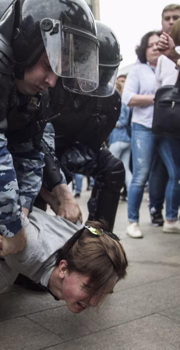 Image: Police detain a protester in Moscow