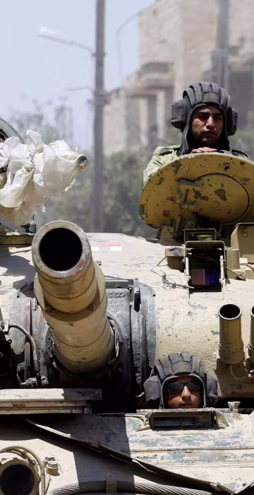 Image: Iraqi soldiers look out from a tank as they advances towards the Islamic State militants positions in the Old City in western Mosul