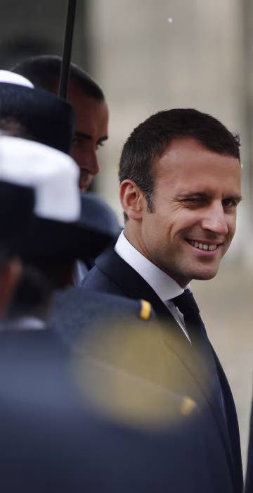 Image: France's President Emmanuel Macron reviews troops