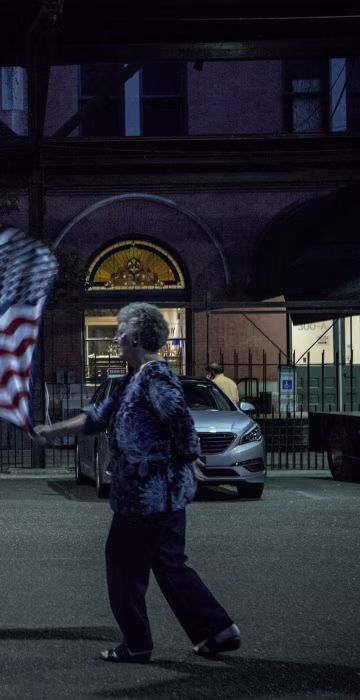 Image: Janie Wall, left, and Betty Kaiser dance with their flags during a debate watching party with supporters of Republican candidate for Senate Roy Moore, at Train Depot in Montgomery, Alabama on Sept. 21.