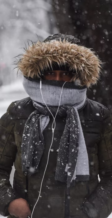 Image: A person walks through the snow during a storm in the Brooklyn borough of New York City