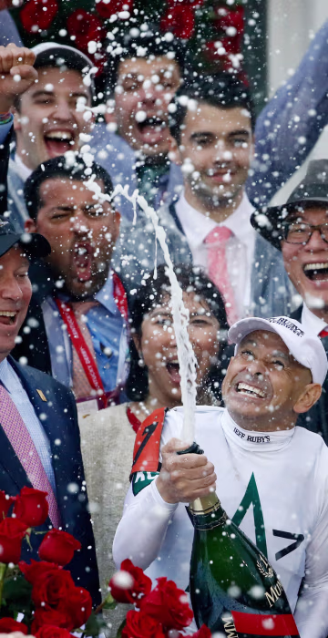 Image: Jockey Mike Smith celebrates after winning the 144th running of the Kentucky Derby