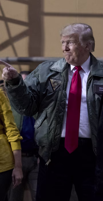 Image: President Donald Trump and first lady Melania Trump greet troops at a hanger rally at Al Asad Air Base in Iraq.