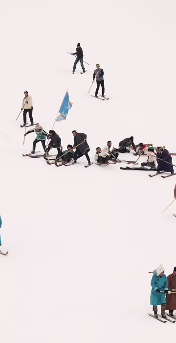 Image: People perform on traditional horsehide skis during an event to celebrate the origins of skiing at the Jiangjunshan ski resort in Altay
