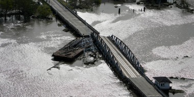A barge damages a bridge that divides Lafitte, La., and Jean Lafitte, in the aftermath of Hurricane Ida, on August 30, 2021.