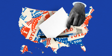 Photo illustration: A handing dropping a ballot card into the map of the United States covered with stickers that read,\"Voted\".