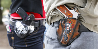 Image: Art and Diana Ramirez of Austin with their pistols in custom-made holsters during and open carry rally at the Texas State Capitol in Austin, Texas, on Jan. 1, 2016.
