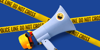Photo illustration: A broken megaphone with a sticker showing the laughing emoji lying over yellow tapes that read,\"Police Line Don't Cross\".