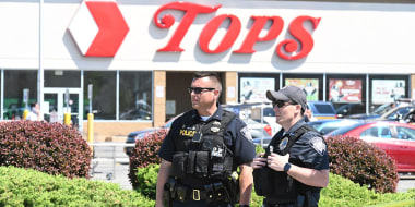 Police stand in front of a Tops Grocery store in Buffalo, New York, on May 15, 2022.
