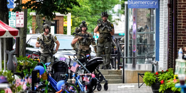 Law enforcement search after a mass shooting at the Highland Park Fourth of July parade in downtown Highland Park, Ill., on July 4, 2022.