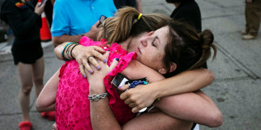 Image: Hillary Heller, Shannon Rowe and Lucy Heller embrace near the scene of a Fourth of July parade mass shooting on July 5, 2022 in Highland Park, Ill.