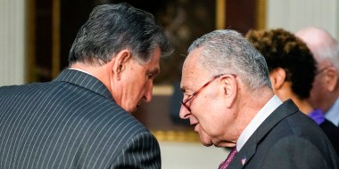 Sen. Joe Manchin, D-W.Va., talks with Senate Majority Leader Chuck Schumer, D-N.Y., before an event in the Indian Treaty Room in the Eisenhower Executive Office Building in Washington on March 15, 2022.