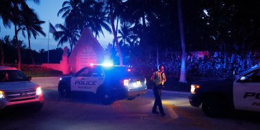 Police direct traffic outside an entrance to former President Donald Trump's Mar-a-Lago estate in Palm Beach, Fla., late Monday.