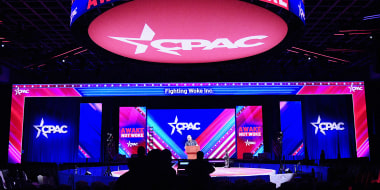 Workers prepare the stage for the 2022 meeting of the Conservative Political Action Conference (CPAC) on Feb. 23.