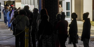 Voters wait in line in Columbus, Ga., on Nov. 27, 2022.