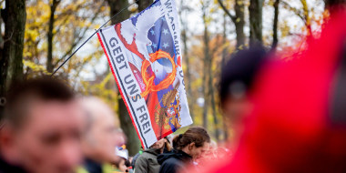Image: A flag of the "QAnon" movement at a demonstration against the corona restrictions of the German government at the Brandenburg Gate in Berlin. The flag reads,"GEBT UNS FREI".