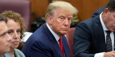 Former President Donald Trump sits at the defense table with his legal team in court