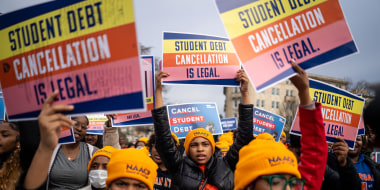 People rally to show support for the Biden administration's student debt relief plan in front of the Supreme Court on Feb. 28, 2023.
