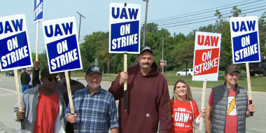 Sen. John Fetterman, D-Pa., walks the picket line in support of the UAW strike in Wayne, Mich.., on Sept. 17, 2023.