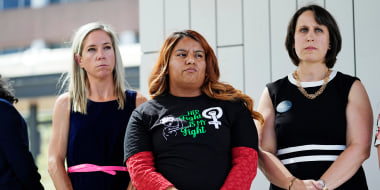Amanda Zurawski, who developed sepsis and nearly died after being refused an abortion when her water broke at 18 weeks, left, and Samantha Casiano, who was forced to carry a nonviable pregnancy to term and give birth to a baby who died four hours after birth, center, stand with their attorney Molly Duane outside the Travis County Courthouse on July 19, 2023, in Austin, Texas. 