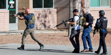 Law enforcement officers head into the University of Nevada, Las Vegas, after reports of an active shooter, Wednesday, Dec. 6, 2023, in Las Vegas.