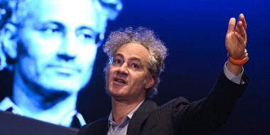 Alex Karp gestures while speaking.
