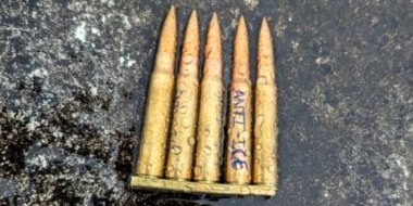 Bullets on the ground with "Anti-ICE" written on one.