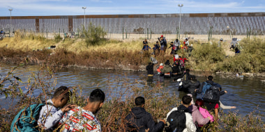 Migrants, predominantly from Venezuela, cross the Rio Grande 