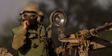 An Israeli soldier drives an armored personnel carrier to a position near Israel Gaza Border, July 10, 2014.