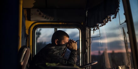 A driver sits inside a bus during an exchange of prisoners-of-war (POWs) near Donetsk, eastern Ukraine