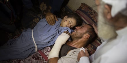 The injured father of 2-year-old Rahaf Hassan cries as he holds her body during the funeral, Oct. 11, 2015, after she and her 30-year-old pregnant mother, Noor Hassan, were killed in Israeli air strike earlier in the day. (Photo by Khalil Hamra/AP)