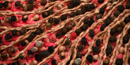 Members of the \"Colla Vella dels Xiquets de Valls\" human tower team form a \"castell\" during the XXVI human towers, or 'castells', competetion in Tarragona, Spain on Oct. 2, 2016. (Photo by Lluis Gene/AFP/Getty)