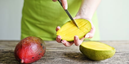 Hand Holding Fresh Mango
