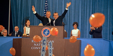 Republican presidential candidate Richard Nixon, waving right, and his running mate Spiro Agnew react to cheers