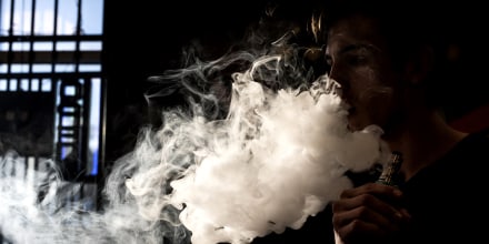 Image: A person smokes an e-cigarette in Albuquerque, N.M., in 2016.