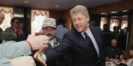 Democratic presidential hopeful Bill Clinton reaches for support while on a campaign stop in Manchester, N.H., on Feb. 13, 1992.