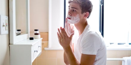 Teen age boy shaving