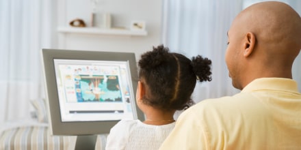 Image: Indian father and daughter looking at computer