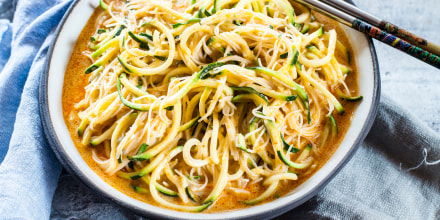 Asian style noodle soup with glas noodles and zoodles in red curry broth
